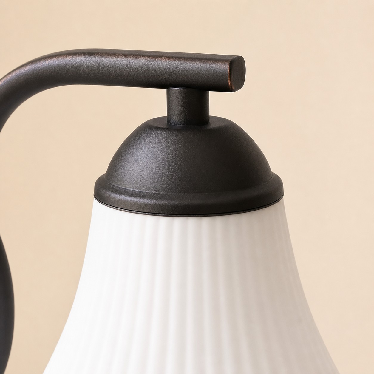 Close view of black metal shade cap and glass shade